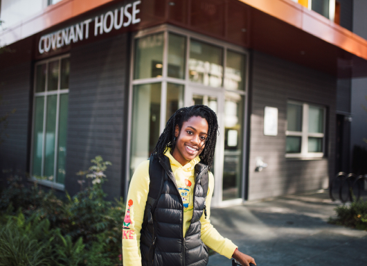 Girl standing in front of CH Location smiling