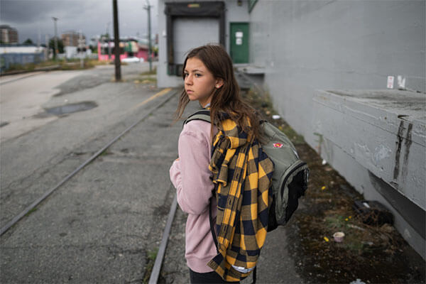 teen homeless girl standing in the street | support homeless shelters