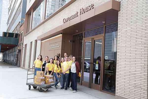 Covenant House staff in front of CHNY receiving laptops from nonprofit Laptops for Kids