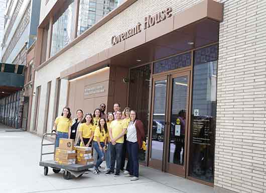 Covenant House staff in front of CHNY receiving laptops from nonprofit Laptops for Kids