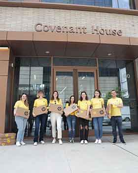 Covenant House staff in front of CHNY receiving laptops from nonprofit Laptops for Kids