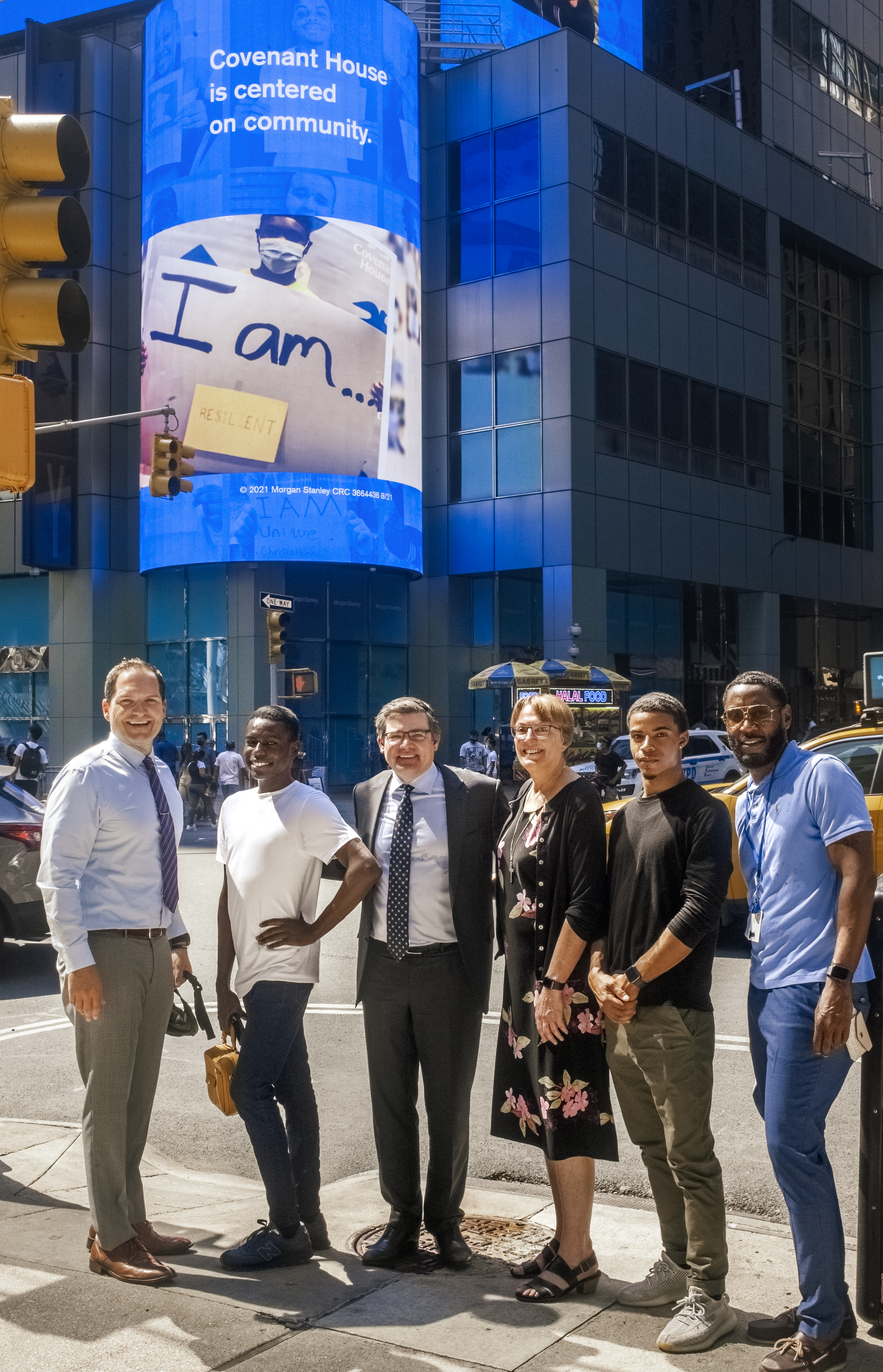 Covenant House Staff Posing for picture in front of CHI and Morgan Stanley Times Square Display