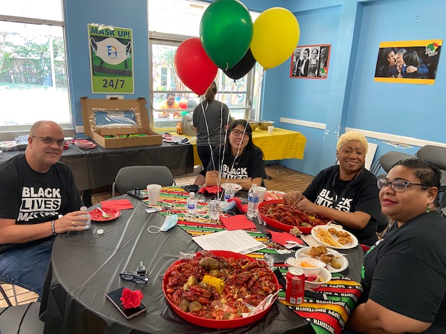 Covenant House Texas Staff sitting together with food and party decorations