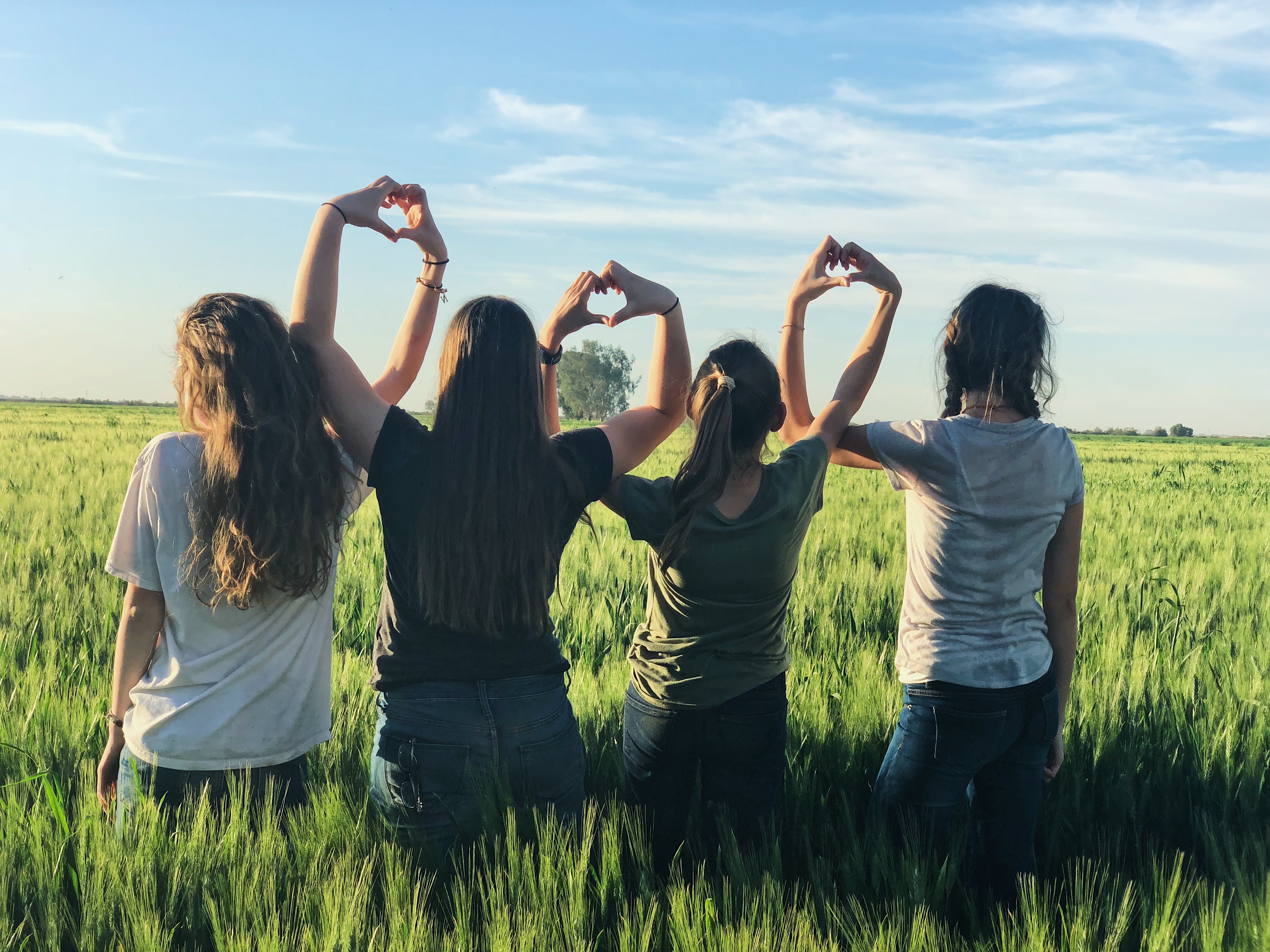 girls making hearts with hands