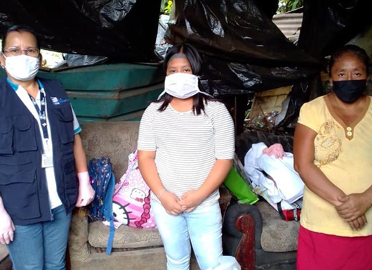 Three women standing together with medical masks on