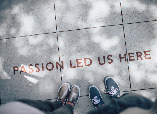 Text on the ground that says "Passion Led Us Here"